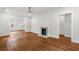 Living room with hardwood floors flowing into dining and kitchen, with a fireplace feature at 1798 S Gordon Sw St, Atlanta, GA 30310