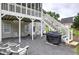 Backyard patio featuring an entertainment area with outdoor seating, swing, and grilling station at 18 Spring Lake Ne Trl, White, GA 30184
