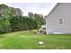View of a spacious backyard featuring lush green grass and mature trees creating a serene outdoor setting at 18 Spring Lake Ne Trl, White, GA 30184