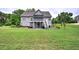 Expansive backyard view with a two-story home featuring a screened porch and outdoor entertaining space at 18 Spring Lake Ne Trl, White, GA 30184