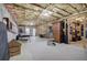 Unfinished basement featuring exposed rafters, concrete flooring, and a storage room for organizational possibilities at 18 Spring Lake Ne Trl, White, GA 30184