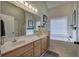 Bathroom features double sink vanity, large mirror, and a separate bathtub at 18 Spring Lake Ne Trl, White, GA 30184