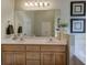 Bathroom featuring a double sink vanity, a large mirror, and decorative wall art at 18 Spring Lake Ne Trl, White, GA 30184