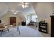 Spacious bonus room with neutral carpet, vaulted ceilings, and flexible workspace for home office or hobbies at 18 Spring Lake Ne Trl, White, GA 30184