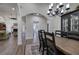 Dining room showcasing a farmhouse-style table, elegant chandelier, and open access to living room at 18 Spring Lake Ne Trl, White, GA 30184