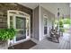 Inviting front porch with stone accents, rocking chairs, and well-maintained landscaping at 18 Spring Lake Ne Trl, White, GA 30184