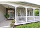 Charming covered front porch with rocking chairs and lovely landscaping at 18 Spring Lake Ne Trl, White, GA 30184
