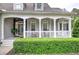 Charming covered front porch with rocking chairs and lovely landscaping at 18 Spring Lake Ne Trl, White, GA 30184