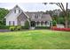 Charming home with manicured lawn, stone accents, and inviting front porch at 18 Spring Lake Ne Trl, White, GA 30184