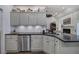 Kitchen with ample counter space, light gray cabinetry, and stainless steel dishwasher at 18 Spring Lake Ne Trl, White, GA 30184