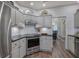 Well-lit kitchen features gray cabinets, stainless steel appliances, and dark countertops at 18 Spring Lake Ne Trl, White, GA 30184
