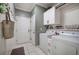 Functional laundry room with a washer, dryer, upper cabinets, and a practical utility sink for added convenience at 18 Spring Lake Ne Trl, White, GA 30184