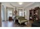 Main bedroom with four-poster bed, tray ceilings, and a cozy sitting area at 18 Spring Lake Ne Trl, White, GA 30184
