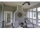 Comfortable screened porch with gray siding, a ceiling fan, and relaxing outdoor seating at 18 Spring Lake Ne Trl, White, GA 30184
