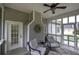 Relaxing screened porch with comfortable seating, ceiling fan, and outdoor access for enjoying the fresh air at 18 Spring Lake Ne Trl, White, GA 30184