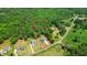 Aerial view showcasing the property's expansive lot, mature trees, and its proximity to surrounding homes at 3610 Burnt Bridge Rd, Cumming, GA 30028