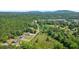 Expansive aerial view of land with mature trees and a neighborhood, illustrating the property's setting at 3610 Burnt Bridge Rd, Cumming, GA 30028