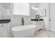 Elegant bathroom featuring a standalone soaking tub, dual sinks, and modern finishes for a luxurious feel at 3610 Burnt Bridge Rd, Cumming, GA 30028