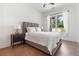 Cozy bedroom featuring a comfortable bed, natural light from a large window, and hardwood floors at 3610 Burnt Bridge Rd, Cumming, GA 30028