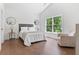 Spacious bedroom with hardwood floors, vaulted ceilings and a comfortable seating area at 3610 Burnt Bridge Rd, Cumming, GA 30028