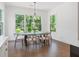 Dining room features large windows, hardwood floors, and a modern chandelier above the dining table at 3610 Burnt Bridge Rd, Cumming, GA 30028