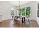 Bright dining room features large windows, hardwood floors, and a modern chandelier above the dining table at 3610 Burnt Bridge Rd, Cumming, GA 30028