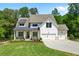 Charming two-story modern farmhouse with a manicured lawn, a welcoming front porch, and a three-car garage at 3610 Burnt Bridge Rd, Cumming, GA 30028