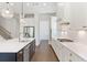 Bright kitchen boasts white cabinets, stainless steel appliances, and a large center island with pendant lighting at 3610 Burnt Bridge Rd, Cumming, GA 30028