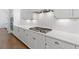 Detailed view of a modern white kitchen with stainless steel appliances and white countertop space at 3610 Burnt Bridge Rd, Cumming, GA 30028