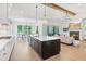 Open-concept kitchen and living room with a fireplace, large island, and stainless steel appliances at 3610 Burnt Bridge Rd, Cumming, GA 30028