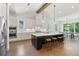 Bright and modern kitchen featuring a dark island, white cabinets, stainless steel appliances, and an adjacent dining area at 3610 Burnt Bridge Rd, Cumming, GA 30028