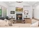 Cozy living room with a fireplace, comfortable seating, and large windows providing natural light at 3610 Burnt Bridge Rd, Cumming, GA 30028