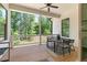 Outdoor porch with a dining table and chairs offering a serene view of the surrounding greenery at 3610 Burnt Bridge Rd, Cumming, GA 30028