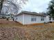 The property's backyard featuring vinyl siding and a leaf-covered lawn at 3647 Diamond Cir, Decatur, GA 30034