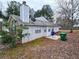 View of the home's backyard with vinyl siding, a small patio, and a chimney at 3647 Diamond Cir, Decatur, GA 30034