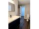 Bathroom features updated vanity with modern fixtures and a door to the hallway at 3647 Diamond Cir, Decatur, GA 30034