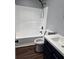 Bathroom with an alcove tub, a toilet and a navy vanity with a white sink at 3647 Diamond Cir, Decatur, GA 30034