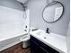 Modern bathroom with blue vanity and tub shower combination in the alcove at 3647 Diamond Cir, Decatur, GA 30034