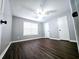 Cozy bedroom with a ceiling fan, wood-look floors, and ample closet space at 3647 Diamond Cir, Decatur, GA 30034