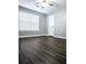Cozy bedroom with laminate wood floor, white window and neutral paint color at 3647 Diamond Cir, Decatur, GA 30034