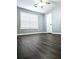 Neutral bedroom features ceiling fan, wood-look floors and a window at 3647 Diamond Cir, Decatur, GA 30034