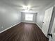 Spacious bedroom with hardwood flooring, baseboards, and a white interior door at 3647 Diamond Cir, Decatur, GA 30034