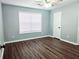 Bright bedroom with laminate wood floor, neutral walls and a big window for natural light at 3647 Diamond Cir, Decatur, GA 30034