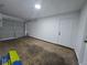 Garage interior with white walls and a roll-up door with door to the right at 3647 Diamond Cir, Decatur, GA 30034