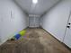 Spacious garage with clean white walls and a roll-up door at 3647 Diamond Cir, Decatur, GA 30034