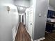 Hallway featuring neutral paint colors, wood-look floors, and access to the kitchen at 3647 Diamond Cir, Decatur, GA 30034