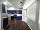 Open kitchen with blue cabinets, stainless steel appliances, and natural light at 3647 Diamond Cir, Decatur, GA 30034