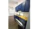 Bright kitchen featuring blue cabinets, wood countertops, and a stainless steel dishwasher at 3647 Diamond Cir, Decatur, GA 30034
