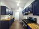 Modern kitchen featuring blue cabinets, wood countertops, and stainless steel appliances at 3647 Diamond Cir, Decatur, GA 30034