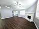 Bright living room with a ceiling fan, a fireplace, and a view of the kitchen at 3647 Diamond Cir, Decatur, GA 30034